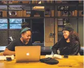  ?? Tony Luong / New York Times 2018 ?? Heather White (left) and Melisa Valdez of Trillfit, a boutique fitness studio, work at the Revolution Hotels co-working space in Boston.