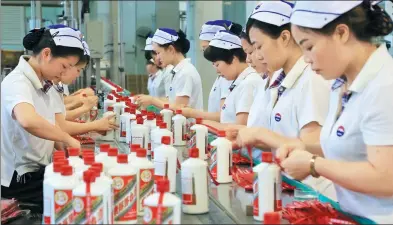  ?? YANG JUN / CHINA DAILY ?? Workers at the packing line of China Kweichow Moutai Distillery Co in Maotai town, Guizhou province.