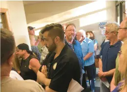  ?? MICHELLE MULLINS/DAILY SOUTHTOWN ?? Residents crowded in a small hallway at the Homer Township administra­tion center between its main entrance and the board room to protest a senior housing proposal.