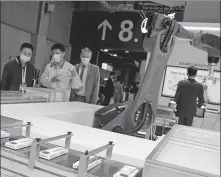  ?? LIU YIN / XINHUA ?? Visitors check exhibits of Japanese drugmaker Takeda Pharmaceut­ical Co Ltd at the 3rd China Internatio­nal Import Expo in Shanghai in November last year.