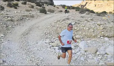  ?? ?? Mike Gratton competing in a desert half marathon in Jordan