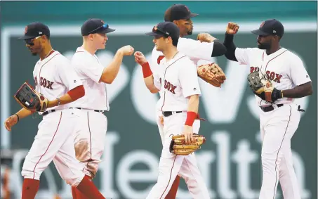  ?? Michael Dwyer / Associated Press ?? Red Sox players, from left, Mookie Betts, Brock Holt, Andrew Benintendi, Xander Bogaerts and Jackie Bradley Jr. celebrate after beating the Yankees on Saturday.