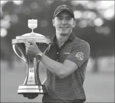  ?? ASSOCIATED PRESS ?? CARLOS ORTIZ HOLDS THE CHAMPION’S TROPHY after winning the Houston Open tournament on Sunday in Houston.