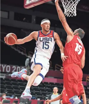  ?? KYLE TERADA/USA TODAY SPORTS ?? Team USA's Devin Booker, left, goes up against Iran's Hamed Haddadi during the Americans' 120-66 victory on Wednesday during the Summer Games at Saitama Super Arena.