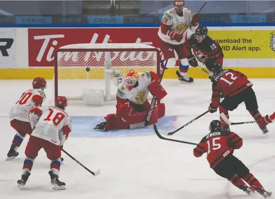  ?? GREG SOUTHAM ?? Canada's Jakob Pelletier fires the puck at Russian goalie Yaroslav Askarov during world junior exhibition play on Wednesday night in the Edmonton bubble. Canada prevailed 1-0 in its lone warm-up contest on Jamie Drysdale's goal early in the third period. Canada opens against Germany on Saturday. For more on the win over Russia, visit vancouvers­un.com