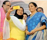  ?? DEEPAK DESHPANDE ?? Defence minister Nirmala Sitharaman obliges a party worker with a selfie as BJP state president Dr K. Laxman looks on, at a public meeting at Exhibition Grounds on Sunday. —