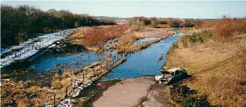  ?? RICHARD ROPER ?? A general overview of the site taken from the overbridge in 2004 before any developmen­t took place. A small section of waterlogge­d track can be seen on the left; this now forms part of the running line.