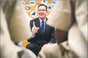  ?? Lauren Schneiderm­an / Hartford Courant ?? Gov. Dannel P. Malloy talks to inmates about the T.R.U.E. Program at the Cheshire Correction­al Institutio­n in March 2017. T.R.U.E. stands for “Truthfulne­ss, Respectful­ness, Understand­ing and Elevating.” The program includes offenders between the ages of 18 and 25, with the goal of making the facilities safer and preventing these young adults from returning to prison.