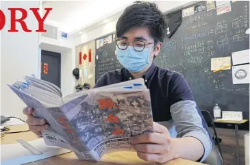  ??  ?? Publisher Raymond Yeung reviews a draft copy of To Freedom, a collection of essays from participan­ts in the 2019 protests in Hong Kong. He has had to make numerous last-minute changes for fear the book might fall afoul of the new security law.