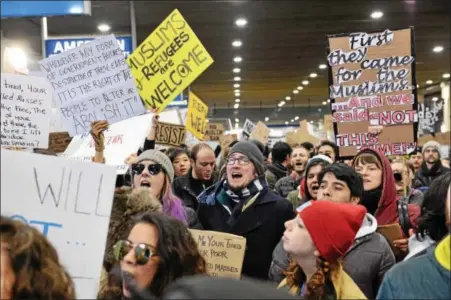  ?? RICK KAUFFMAN — DIGITAL FIRST MEDIA ?? Protesters gather outside the American Airlines arrival terminal at the Philadelph­ia Internatio­nal Airport to protest on immigrants from Muslim counties recently signed by executive order by President Donald Trump.