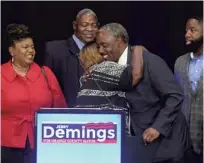  ?? RED HUBER/STAFF PHOTOGRAPH­ER ?? Orange County Sheriff Jerry Demings hugs family members Tuesday after being elected Mayor of Orange County in a landslide.