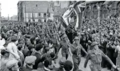  ?? AP FILE PHOTO ?? American and British flags march with the Tricolor of France in Cherbourg in 1944 on the annual observance of Bastille Day.