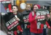  ?? — Reuters ?? Striking AT&T workers picket outside an AT&T store on Michigan Avenue in Chicago.