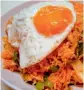  ??  ?? Nasi Goreng Stir-fried rice prepared with chicken or shrimps, chillis and garlic. It is served with a fried egg as garnish.