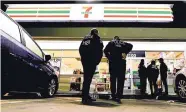  ?? CHRIS CARLSON/ASSOCIATED PRESS ?? U.S. Immigratio­n and Customs Enforcemen­t agents serve an employment audit notice at a 7-Eleven convenienc­e store Wednesday in Los Angeles.