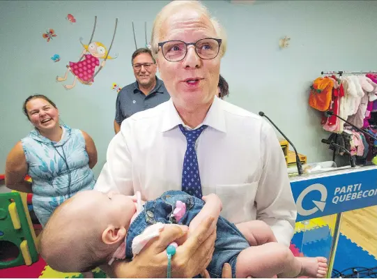  ?? RYAN REMIORZ/THE CANADIAN PRESS ?? PQ Leader Jean-François Lisée holds three-month-old Flavie Adam after proposing improvemen­ts to the parental leave plan on Wednesday in Nicolet. Lisée made it clear that Pierre Marcotte, PQ candidate for Drummond—Bois-Francs, is no longer running for the party after he expressed anti-Muslim views on social media.