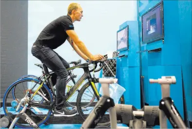  ??  ?? Exhibitor Menno Van Beelen rides a stationary bike that connects to a virtual bike-riding experience Wednesday at the Interbike Exposition at the Mandalay Bay Convention Center.