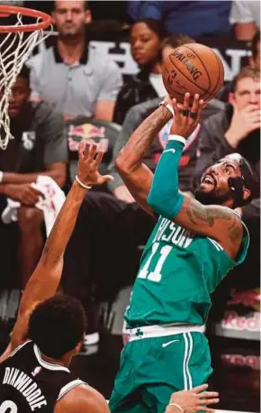  ??  ?? Celtics’ Kyrie Irving (right) drives to the basket as the Nets' Spencer Dinwiddie defends during their NBA game in Brooklyn on Tuesday. EPA PIC