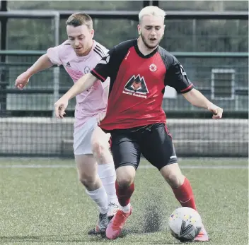  ??  ?? Andrew Irvine (red) in action for Netherton United against Eynesbury United at the Grange. Photo: Chris Lowndes.