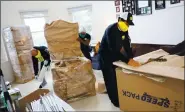  ?? ARIC CRABB — STAFF ARCHIVES ?? CG Moving Company workers wrap and pack items in an apartment unit on April 20, 2020, in Redwood City.