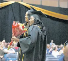  ?? SUZANNE TENNANT/POST-TRIBUNE PHOTOS ?? Nursing school graduates Tiffany Ruffin, left, and Jacqueline Harding participat­ed in commenceme­nt Saturday.