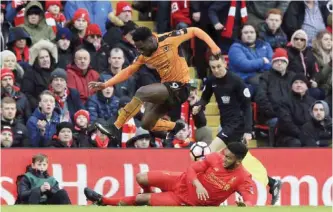  ??  ?? ANFIELD: Wolverhamp­ton Wanderers’ Nouha Dicko jumps as he vies for the ball with Liverpool’s Joe Gomez during the English FA Cup, fourth round soccer match between Liverpool and Wolverhamp­ton Wanderers, at Anfield, in Liverpool, England, yesterday. — AP