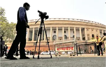  ??  ?? File photo shows television journalist­s reporting from the premises of India’s Parliament in New Delhi, India. — Reuters photo