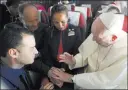  ??  ?? The Associated Press Pope Francis marries flight attendants Carlos Ciuffardi, left, and Paola Podest, center, during a flight Thursday from Santiago, Chile, to Iquique, Chile.