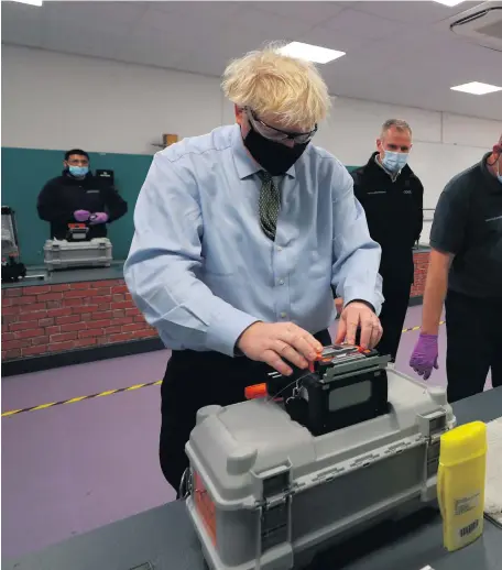  ??  ?? Hands on: Prime Minister Boris Johnson during a visit to the Openreach L&D Training Centre in Bolton yesterday