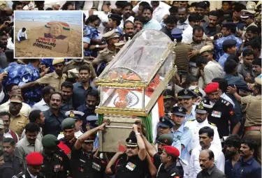  ??  ?? CHENNAI: Indian army and air force officers carry the body of India’s popular politician and former film actress Jayaram Jayalalith­aa in a glass casket during her funeral procession in Chennai, India yesterday. (Inset) Indian sand artist Sudarsan...