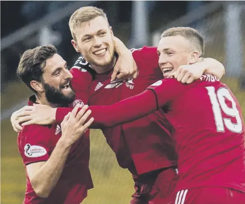  ??  ?? 2 Sam Cosgrove, centre, celebrates his second goal with Aberdeen captain Graeme Shinnie and Lewis Ferguson.