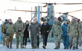  ?? ANDREW MATTHEWS/PA ?? British Prime Minister Rishi Sunak, center right, and Ukrainian President Volodymyr Zelenskyy arrive Wednesday in Lulworth, England, to meet Ukrainian troops.