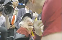  ?? DAVID GOLDMAN/THE ASSOCIATED PRESS ?? Loyola Chicago basketball chaplain Sister Jean Dolores Schmidt celebrates the Ramblers’ win with guard Ben Richardson.