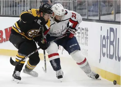  ?? AP FiLE ?? HOLDING OUT HOPE: Boston’s Paul Carey battles Washington’s Radko Gudas for the puck during the first period on Nov. 16. At bottom, from left, Peter Cehlarik, Carey and Anders Bjork vie for the puck during practice at Warrior Ice Arena on Sept. 13.