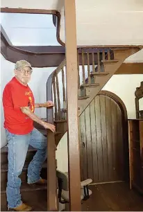  ??  ?? Eugene Stanton shows the stairway where ghost shoes were said to have walked during Stanton’s childhood days when he played inside the abandoned plantation home.