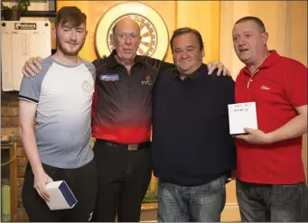  ??  ?? Division 2 League winners Kyle Ryan, Charlie Byrne, Damian Douglas with darts profession­al John Lowe at the Wicklow Darts presentati­on night at the Woodpecker Ashford recently.