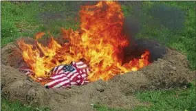  ?? FRAN MAYE – DIGITAL FIRST MEDIA ?? American flags burn at a flag-burning ceremony Sunday in Kennett Square.