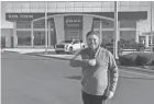  ?? ?? Ricart Automotive President Rick Ricart stands in front of the Dan Tobin dealership that Ricart Automotive has acquired.