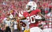  ?? WALLY SKALIJ / LOS ANGELES TIMES ?? Stanford running back Bryce Love stiff-arms USC cornerback Iman Marshall in the second quarter at Stanford Stadium on Saturday.