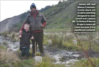  ?? PENNY WARDLE/STUFF ?? James, left, and Mason Colemancow­ie check out a native planting designed to slow runoff and capture silt. Te Hoiere/pelorus Project covers all costs because it is a significan­t wetland.