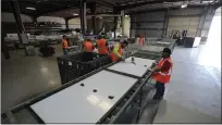  ?? GREGORY BULL THE ASSOCIATED PRESS ?? Workers take apart solar panels as they begin the recycling process at We Recycle Solar on June 6 in Yuma, Ariz.