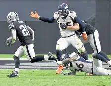  ?? Andy Cross, The Denver Post ?? Raiders running back Josh Jacobs, left, races to the end zone for a touchdown against Broncos outside linebacker Bradley Chubb ( 55) and safety Trey Marshall ( 36) in the third quarter at Allegiant Stadium on Sunday.