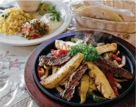  ?? Melissa Phillip photos / Houston Chronicle ?? Rita’s Cantina’s beef and chicken fajita platter features tender skirt steak and works with flour tortillas or its supple corn ones.