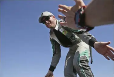  ?? LM OTERO — ASSOCIATED PRESS ?? Dale Earnhardt Jr. reaches to fans during driver intros before the NASCAR race at Texas Motor Speedway in Fort Worth, Texas on Nov. 5.