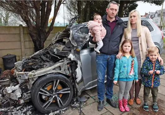  ??  ?? Narrow escape: Miles Freeman and Tanya Krupenko with children Savannah, Olivia and Harrison by the burnt-out Volvo