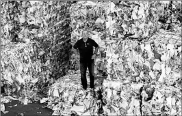  ?? CHARLES KRUPA/AP ?? Ben Harvey stands among bundles of paper and cardboard at EL Harvey &amp; Sons in Westboroug­h, Mass.