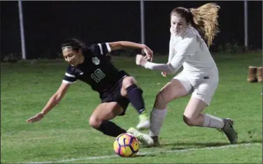  ?? MIKE BUSH/NEWS-SENTINEL ?? Above: Lodi striker Emily Souza, right, goes after the soccer while St. Mary's fullback Haley Quarles falls down in the first half of Wednesday's TCAL contest. Lodi’s Shaina Hummel (12) battles St. Mary's defender Abigail Kern (29).