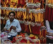  ?? — BIPLAB BANERJEE ?? A shop is decorated with “rakhis” ahead of Raksha Bandhan at a market in New Delhi on Tuesday.