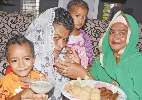  ?? Photo: Ronald Kumar ?? Sainaaz Bi (right), shares the joy of Eid al-Fitr with her neighbours, Makalesi Ratuvou and her children Grace and Josefa Ratuvou in Koronavia, Nausori, on June 15, 2018.