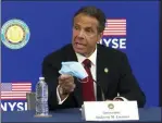  ?? TED SHAFFREY ?? New York Gov, Andrew Cuomo holds his face mask while talking to the media at the New York Stock Exchange, Tuesday, March 26, 2020. Gov. Cuomo rang the opening bell as the trading floor partially reopened during the coronaviru­s pandemic.